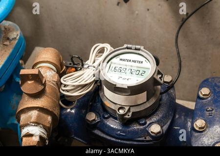 Water meter in building with commercial and residential units. Digital measuring device for water usage of property and accuracy in billing of water c Stock Photo