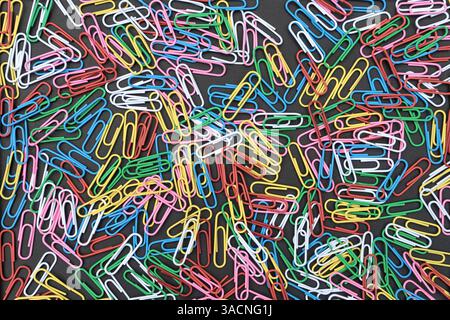 Black background with colorful paper clips, Stock Photo