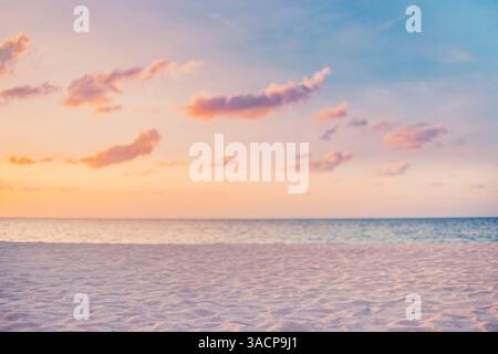 Tropical beach at sunset, vibrant skies reflecting on calm water sand, gentle waves splash shore, serene atmosphere under colorful sky, peaceful sea Stock Photo