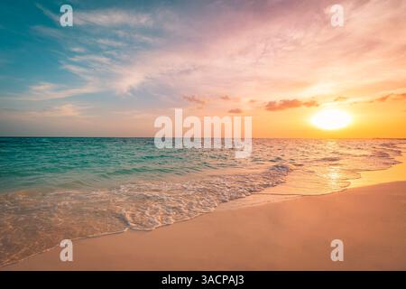 Tropical beach at sunset, vibrant skies reflecting on calm water sand, gentle waves splash shore, serene atmosphere under colorful sky, peaceful sea Stock Photo