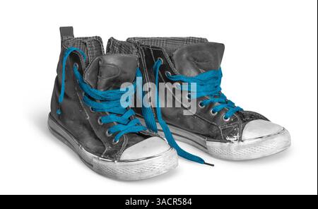 Pair of rundown sneakers with blue shoelaces in white back with shadow Stock Photo