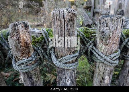 Rustic fence made from wooden slats and a rope Stock Photo