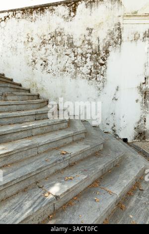 Old stone staircase with weathered house wall Stock Photo