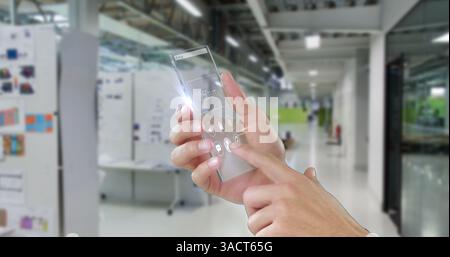 In office hallway, person interacting with futuristic transparent smartphone screen Stock Photo