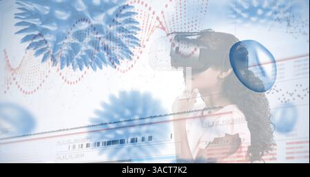 Girl using VR headset exploring digital world with futuristic graphics overlay Stock Photo