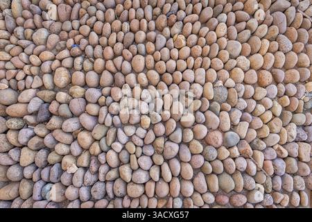 Saudi Arabia, Tabuk, Duba. Wall made of rounded stones. Stock Photo