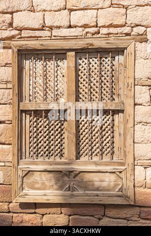 Saudi Arabia, Medina. Barred and shuttered wooden window in old town Al-Ula. Stock Photo