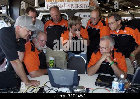Sep. 28, 2005 - Fontana, California, USA - Members of the Indy Robot Racing Team, from Indianapolis, Indiana, gather around a computer to review data from their qualification run on Thursday, Sept. 29, 2005 at the DARPA Grand Challenge in Fontana, CA.  DARPA (the Defense Advanced Research Projects Agency), the central research and development organization of the United States Department of Defense, has offered a  million prize to the winning robotics team whose autonomous ground vehicle successfully traverses approximately 150 miles of rugged Mojave Desert roads using only onboard sensors and Stock Photo