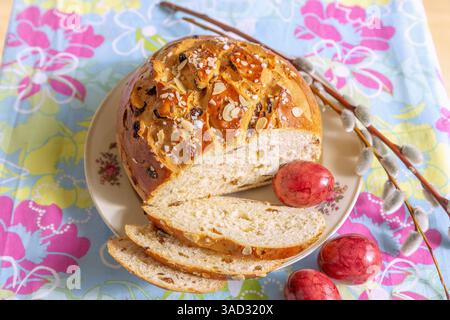 Easter cake with colorful Easter eggs on a plate and colorful tablecloth Stock Photo