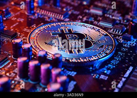 Bitcoin coin on a computer board Stock Photo