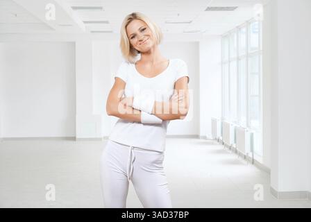 Beautiful sportswoman wearing white sport clothes Stock Photo
