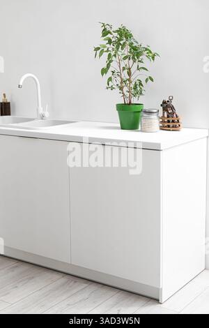White counters with sink and utensils in light kitchen Stock Photo - Alamy
