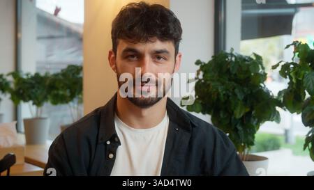 Caucasian man using mobile phone smartphone laptop working online male happy client visitor cafe restaurant employee positive smiling guy businessman Stock Photo
