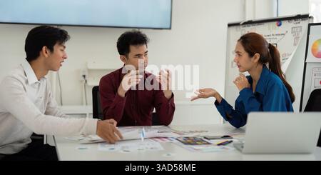 Interactive UX UI Brainstorming. Designers animatedly discuss creative ideas and approaches for effective user interface design. Stock Photo