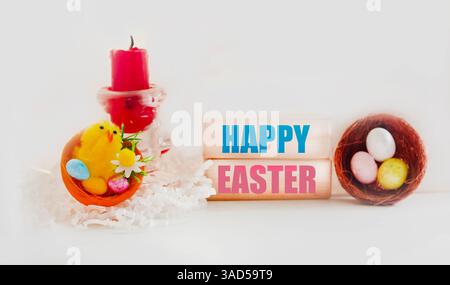 A bright, positive Easter Spring composition. Easter inscription on wooden blocks on a light background. Colorful decorated eggs Stock Photo