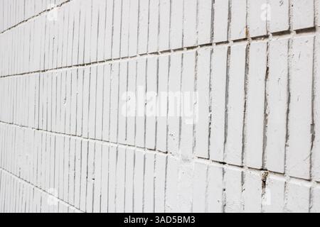 This image features a detailed closeup view of a white brick wall, showcasing the texture and structure of the composite material Stock Photo