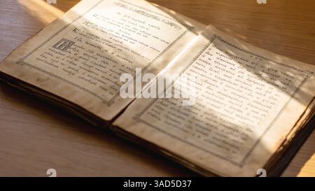 Belarus, Minsk - 09.03.2025: In a book, open to a specific page, there is clearly the letter a written on it, waiting to be read and explored further Stock Photo