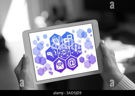 Email marketing concept shown on a tablet held by a woman Stock Photo
