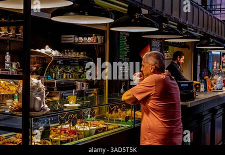 A man drinking an espresso coffee at Mercato di Mezzo, a lively covered food market in the centre of Bologna,Italy Stock Photo