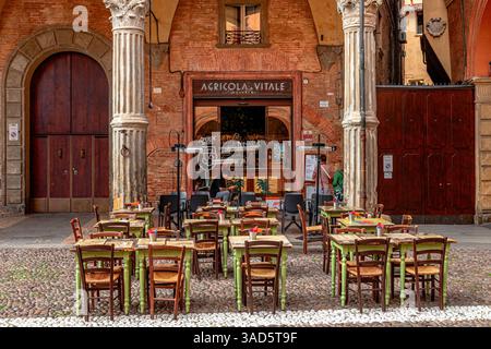 Tables and chairs in front of Agricola Vitale a restaurant in Piazza Santo Stefano,Bologna ,Italy Stock Photo