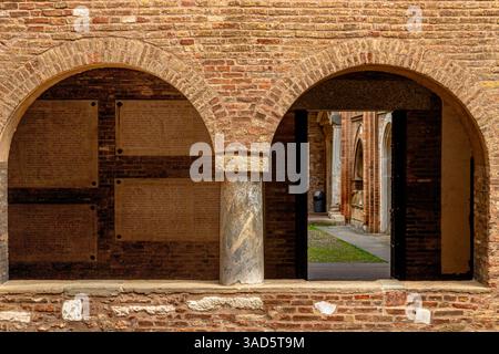 Twin arches in a brick wall  inside the Basilica di Santo Stefano in  Piazza Santo Stefano ,Bologna, Italy Stock Photo