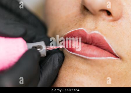Professional lip micropigmentation procedure in beauty clinic Stock Photo