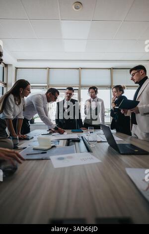 Diverse team collaborates in a modern business meeting Stock Photo
