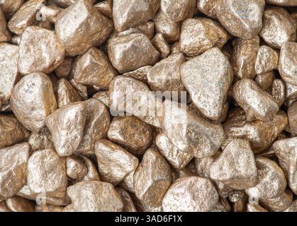 Macro shot of a group of gold coloured stones. Stock Photo