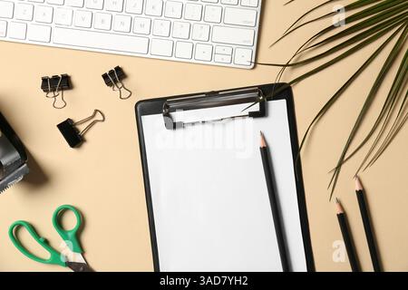 Flat lay composition with clipboard and blank paper on beige background. Space for text Stock Photo