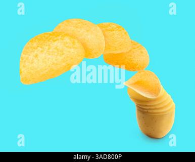 Raw potato slices transforming into crispy chips in air on light blue background Stock Photo