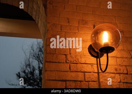 Decorative antique edison style light bulbs against brick wall background Stock Photo