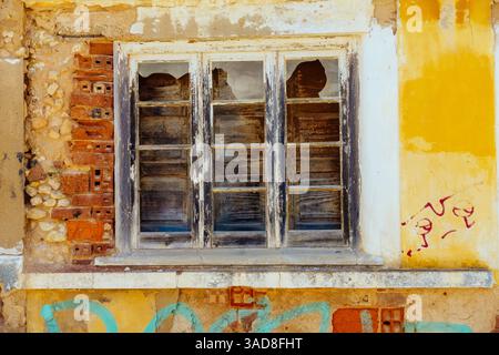 Colourful weathered window frame with broken glass, Lagos, algarve, Portugal Stock Photo