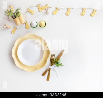 Happy Easter. Easter celebration concept. Top view vertical empty white and yellow plate, Easter eggs, on isolated white background. Copy space, place Stock Photo