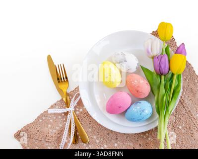 Happy Easter. Easter celebration concept. Top view vertical empty white and yellow plate, Easter eggs, on isolated white background. Copy space, place Stock Photo