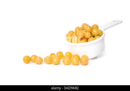 Isolated golden cherries with measuring cup. Small yellow orange cherries. Aunt Molly’s ground cherry harvest. Ground cherry, Poha berry, pichuberry, Stock Photo