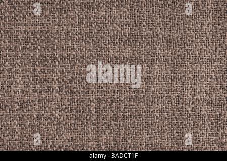 Upholstery brown colored jacquard fabric coarse weave texture. Textile background, furniture textile material, wallpaper, backdrop. Cloth structure cl Stock Photo