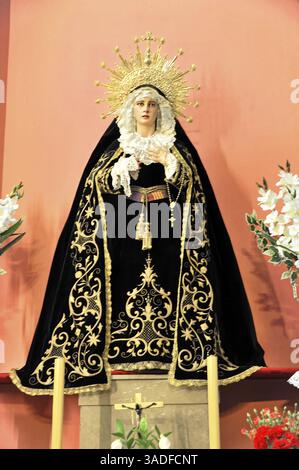La Merced or Church of Our Lady of Mercy, Religious figure with black cloak and golden embroidery in front of a red wall, Ronda, Province of Malaga, A Stock Photo