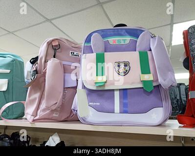 Aktau, Kazakhstan - March 22, 2025: Colorful backpacks on display in a store with cartoon design details. Stock Photo