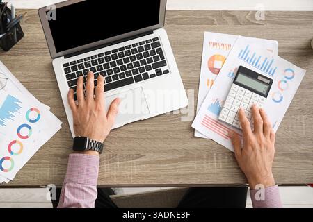 Office worker using calculator at table. Top view Stock Photo