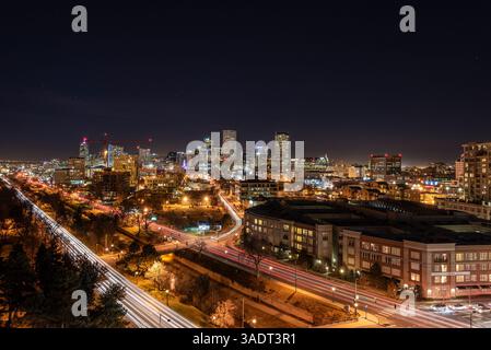 Vibrant Night Skyline with Illuminated Cityscape and Trails of Lights Stock Photo