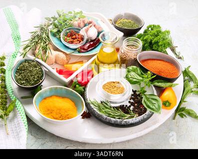 Fresh and dried herbs and spices on a grey background. Cooking, healthy eating concept. Top view. Stock Photo