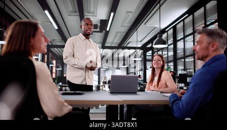 Diverse Group Of Professionals Collaborating In A Corporate Office Meeting. Stock Photo
