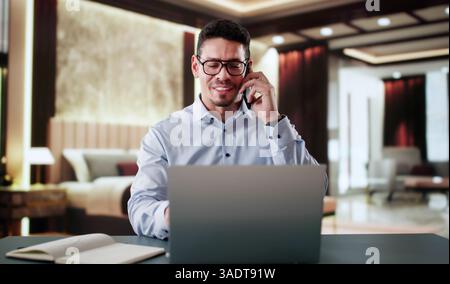Entrepreneur Man In Hotel On Business Travel Vacation Using Mobile phone Stock Photo