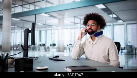 Office Worker Making Compensation Call for Broken Arm Coverage Stock Photo