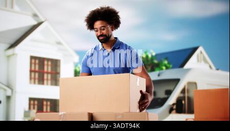 Professional Mover Unloading Boxes from Van in a Residential Neighborhood. Stock Photo