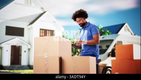 Professional Mover Unloading Van, Holding Boxes and Delivering to House. Stock Photo