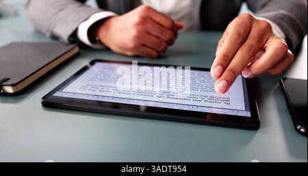 Young African-American man reviews digital script for online publication editing. Stock Photo