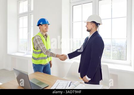 Worker Shaking Hands With Client To Confirm Construction Project Stock Photo
