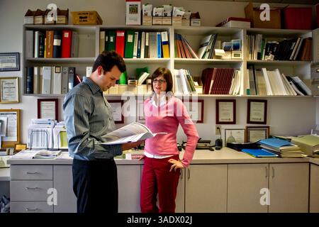 May 22, 2008 - Irvine, California, USA - Two office workers discuss a prospectus at a financial consultant's office in Irvine, California (Credit Image: Spencer Grant/ZUMAPRESS.com) Stock Photo