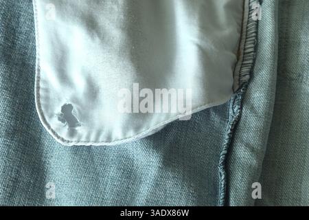 tear on side pocket jean pant fabric texture and background Stock Photo